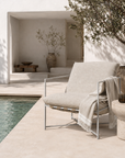 Chair by a pool with a neutral color palette