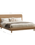 Flynn Oak Bed by KULALA Living shown from perspective, featuring natural wood finish and modern bed frame design.