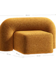 A luxurious mustard lounge chair with a sculptural, curved backrest and a matching ottoman, offering a bold yet elegant statement piece for contemporary interiors.