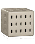 Niche side table in sand finish with perforated detailing creating a sculptural form with soft tonal warmth.