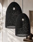 Two black woven pendant lights hanging against a neutral wall.