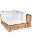 Natural wicker corner chair with thick white cushions, showcasing a coastal-inspired design perfect for indoor and outdoor settings