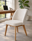 Alma dining chair in seashell tone with soft upholstery and rope detailing styled at a timber desk in a calm modern australian interior