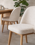 Alma dining chair in seashell tone with soft upholstery and rope detailing styled at a timber desk in a calm modern australian interior