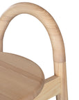 A minimalist solid ashwood bar stool with a curved backrest and natural finish, designed for modern kitchen and bar spaces.