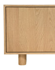 Bajo Entertainment Unit in natural oak with four flat-panel doors and a low-profile design.