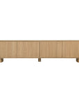 Bajo Entertainment Unit in natural oak with four flat-panel doors and a low-profile design.