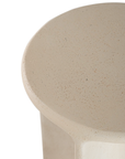 Berber side table in driftstone finish featuring sculptural curved legs and a softly rounded top with a textured natural surface.