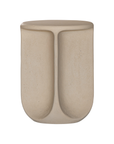 Berber side table in driftstone finish featuring sculptural curved legs and a softly rounded top with a textured natural surface.