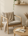 Billie Occasional Chair with natural oak frame and soft textured cushions, styled in a minimalist reading nook with neutral decor and a linen throw