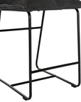 Black cushioned bar stool with a plush, padded seat and backrest, supported by a sleek black metal frame for a modern and comfortable seating option