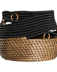 Black and natural woven basket with circular accents, ideal for decorative storage and adding texture to interior spaces.