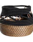 Black and natural woven basket with circular accents, ideal for decorative storage and adding texture to interior spaces.