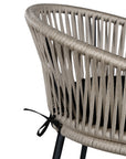 Black natural outdoor bar chair featuring a woven rope backrest and sleek metal legs, designed for modern alfresco dining and stylish patio settings