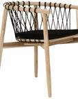 Modern black natural wooden dining chair with woven rope backrest and cushioned seat, perfect for contemporary lounge settings
