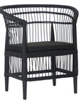 A stylish black rattan dining chair with an intricate woven design and a sleek black cushion, adding a modern touch to any dining or seating area