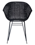Black rattan dining chair with curved back and slim metal legs, perfect for modern and stylish dining settings