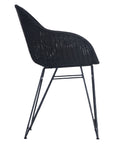 Black rattan dining chair with curved back and slim metal legs, perfect for modern and stylish dining settings