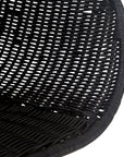 Black rattan dining chair with curved back and slim metal legs, perfect for modern and stylish dining settings