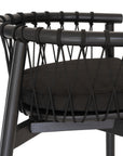 Modern black wooden barchair with woven rope backrest and cushioned seat, perfect for contemporary lounge settings