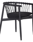Modern black wooden dining chair with woven rope backrest and cushioned seat, perfect for contemporary lounge settings