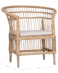 A beautifully crafted blonde rattan armchair with an open-weave design and a white cushioned seat, perfect for adding a relaxed coastal touch to any space.