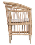 A beautifully crafted blonde rattan armchair with an open-weave design and a white cushioned seat, perfect for adding a relaxed coastal touch to any space.