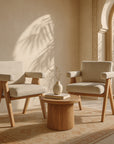Pair of Buhle Armchairs with oak timber legs and neutral upholstery styled in a sunlit Mediterranean-inspired living space