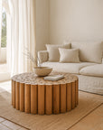 Caribbean Coffee Table in solid teak with a rounded slat design, styled in a serene living room with neutral tones and natural light