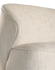 Coroo occasional chair in natural textured fabric with a soft curved backrest and rounded silhouette on a low plinth base.