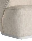 Coroo occasional chair in natural textured fabric with a soft curved backrest and rounded silhouette on a low plinth base.