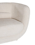 A modern curved armchair upholstered in soft ivory bouclé fabric from KULALA Living. Designed for comfort and style, this contemporary accent chair adds elegance to any living space