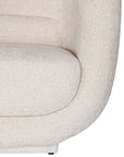 A modern curved armchair upholstered in soft ivory bouclé fabric from KULALA Living. Designed for comfort and style, this contemporary accent chair adds elegance to any living space
