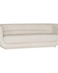 A modern curved sofa upholstered in soft ivory bouclé fabric from KULALA Living. Designed for comfort and style, this contemporary accent chair adds elegance to any living space