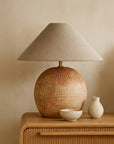 Debele clay table lamp with a natural linen shade styled on a timber bedside with ceramic decor in a warm neutral bedroom setting