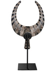 A striking decorative tribal horn sculpture with bold black and natural tones, mounted on a sleek black stand, adding an artisanal touch to modern interiors.