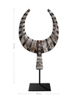 A striking decorative tribal horn sculpture with bold black and natural tones, mounted on a sleek black stand, adding an artisanal touch to modern interiors.