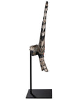A striking decorative tribal horn sculpture with bold black and natural tones, mounted on a sleek black stand, adding an artisanal touch to modern interiors.