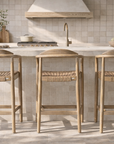 Dedon outdoor counter chair with woven rope seat and backrest, designed for relaxed alfresco dining and outdoor entertaining.