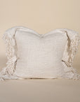 A beautifully textured handwoven linen cushion cover in a soft natural hue, featuring delicate fringe details for a relaxed, organic look. Ideal for layering on sofas or beds