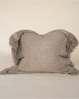 A beautifully textured handwoven linen cushion cover in a soft natural hue, featuring delicate fringe details for a relaxed, organic look. Ideal for layering on sofas or beds