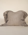 A beautifully textured handwoven linen cushion cover in a soft natural hue, featuring delicate fringe details for a relaxed, organic look. Ideal for layering on sofas or beds