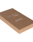 A pair of handcrafted black iron scissors with a vintage-inspired design, presented in a minimalist brown cardboard box