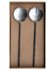 A set of handcrafted black metal salad servers from KULALA Living, featuring a modern rustic design with textured handles, elegantly presented in a gift box
