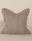 Soft natural linen cushion with a hand-stitched patchwork design, adding texture and warmth to any living space