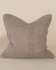 Soft natural linen cushion with a hand-stitched patchwork design, adding texture and warmth to any living space