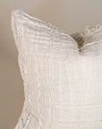 Soft off-white linen cushion with a hand-stitched patchwork design, adding texture and warmth to any living space