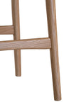 The Kulala Living Handwoven Counter Stool in natural features a meticulously woven seat crafted from durable fibre, supported by a solid timber frame with a sleek black finish. This modern yet timeless piece adds texture and sophistication to kitchen and bar spaces.
