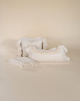 A soft, handwoven cream throw with delicate fringed edges, draped elegantly against a neutral backdrop. Crafted from natural fibres, this textured blanket adds warmth and effortless style to any living space