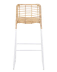 A stylish bar stool featuring a handwoven natural rattan seat and a sleek white metal frame. Designed for modern coastal and contemporary spaces, this lightweight yet sturdy stool adds texture and warmth to kitchen and bar areas